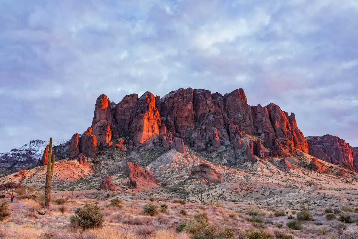 Superstition Mountain in evening light, with a saguaro in the foreground